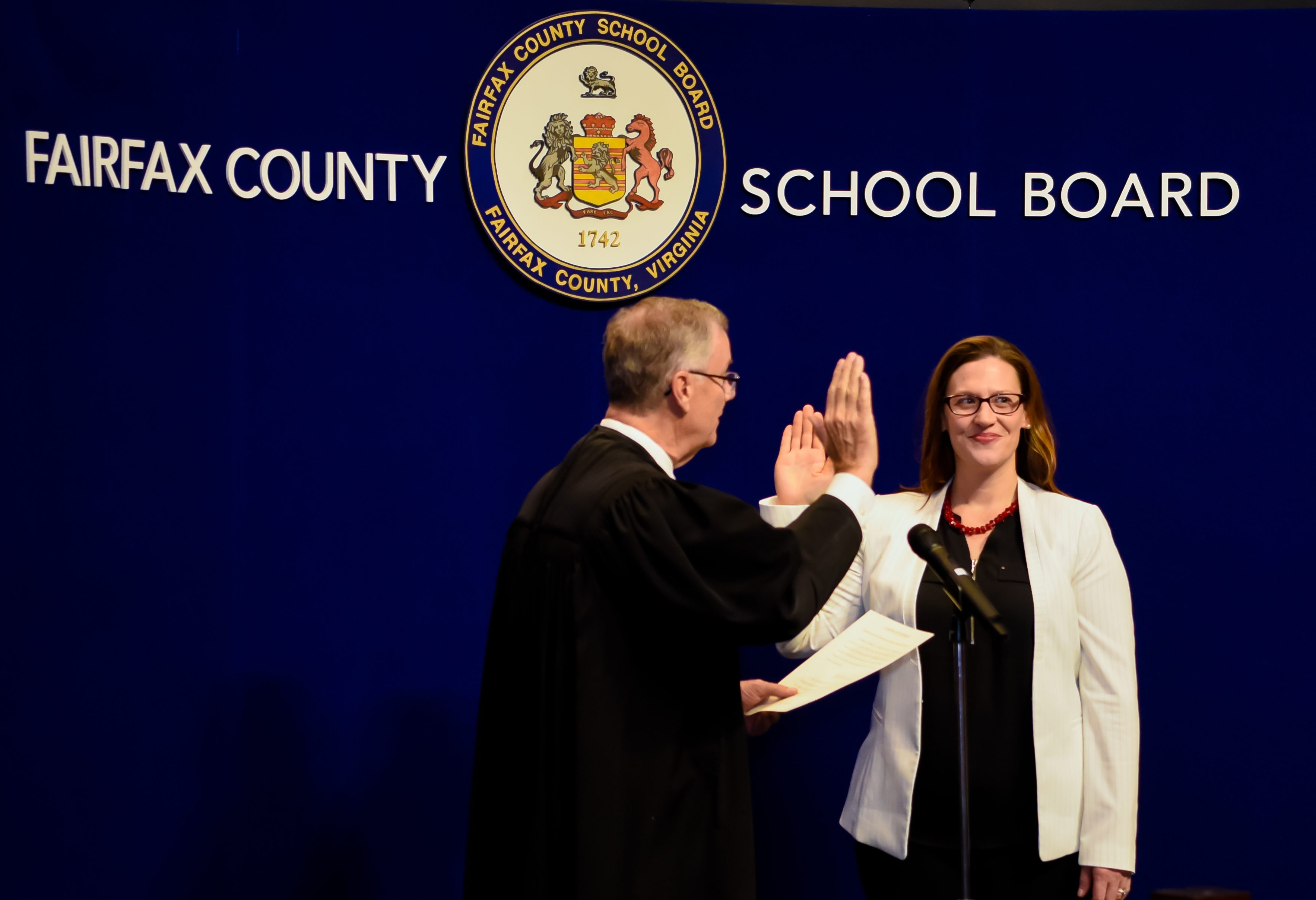 Melanie Meren on a stage being sworn into her position on the FCPS Board